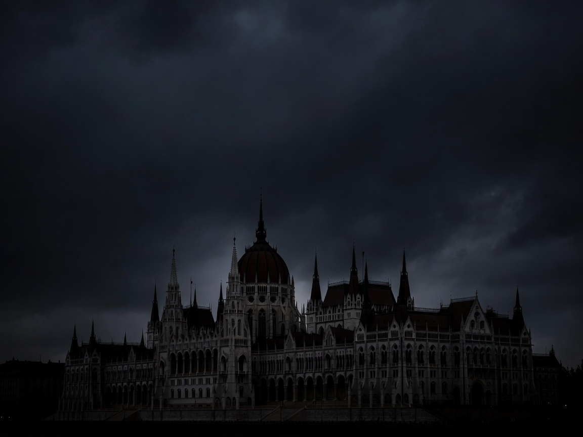 Old European parliament building silhouette against a dark sky